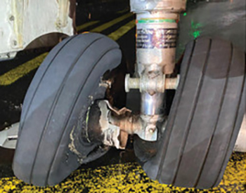 Figure 4 - Overload fracture of right nose wheel (left nosewheel similarly damaged)
