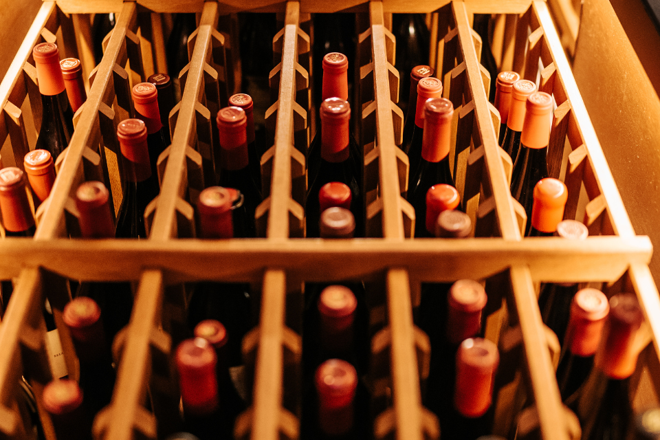 Image of wine bottles stored in a wooden rack