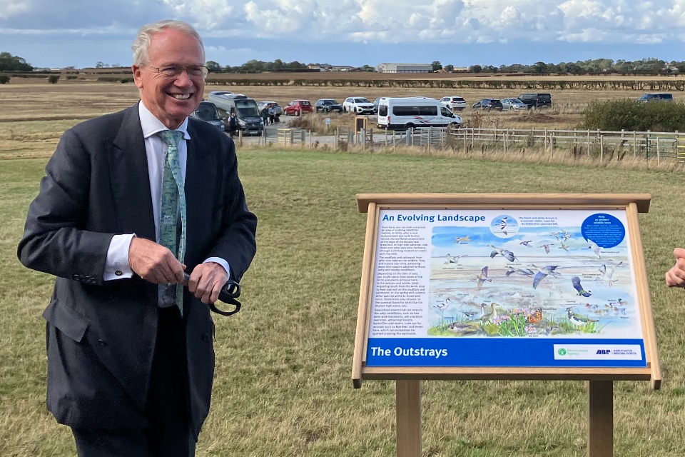 Alan Lovell unveils an interpretation board during an event to celebrate the completion of the Outstray Managed Realignment Scheme