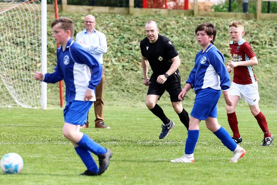 Secretary of State Chris Heaton-Harris referees a football match at Crewe Park, which is receiving UK Government Grassroots Facilities funding