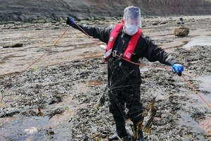 An Environment Agency fisheries officer seizes the illegal fishing net at Skinningrove