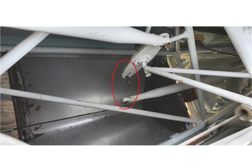 Image: Showing bellcrank and disconnected pivot joint after recovery to the hangar, view looking towards top of fuselage, cockpit is to the left.