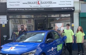 Tommy Sandhu and students enjoying using an electric vehicle funded by Highways England