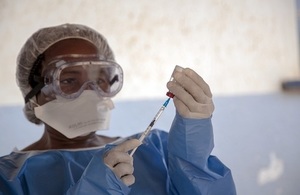 An Ebola vaccination team member prepares to administer the Ebola vaccine in the Democratic Republic of the Congo