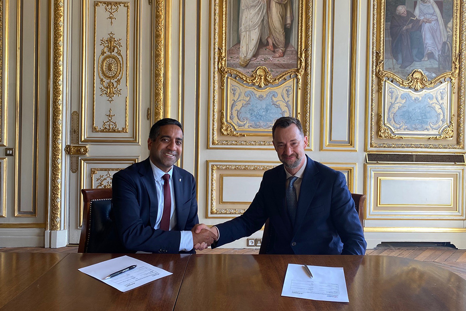 Axiom Space CRO Tejpaul Bhatia (left) and UK Space Agency CEO Paul Bate (right) shaking hands after signing the agreement between Axiom Space and the UK Space Agency